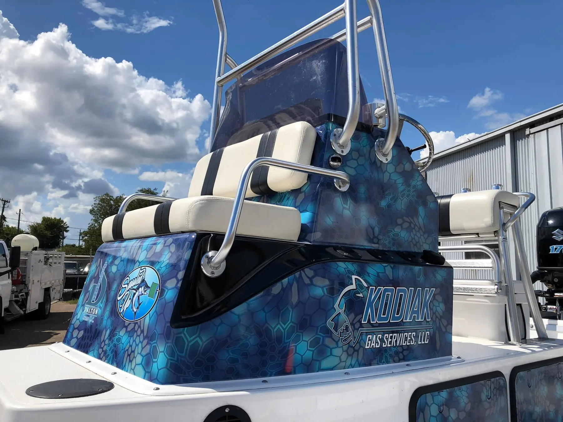 Bay boat console wrapped in blue camo vinyl with Kodiak Gas Services branding