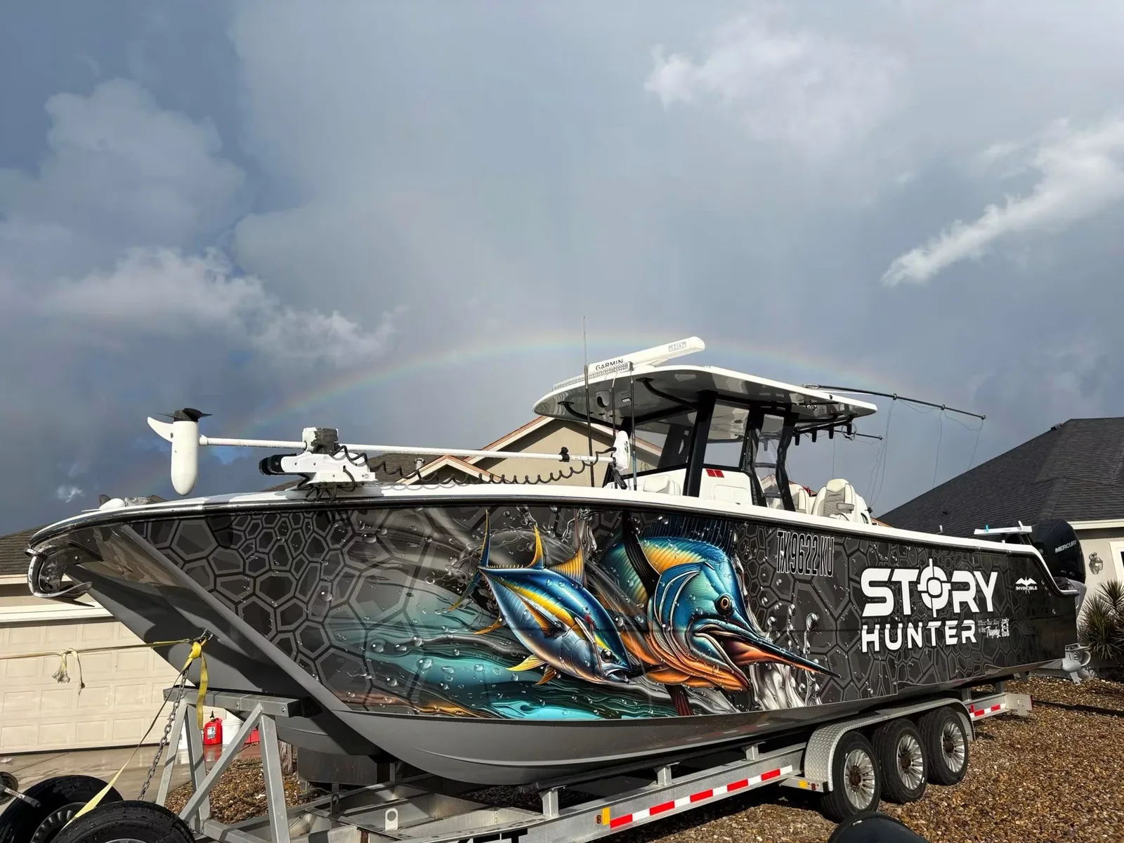 STORY HUNTER center-console boat wrapped with marlin and tuna artwork