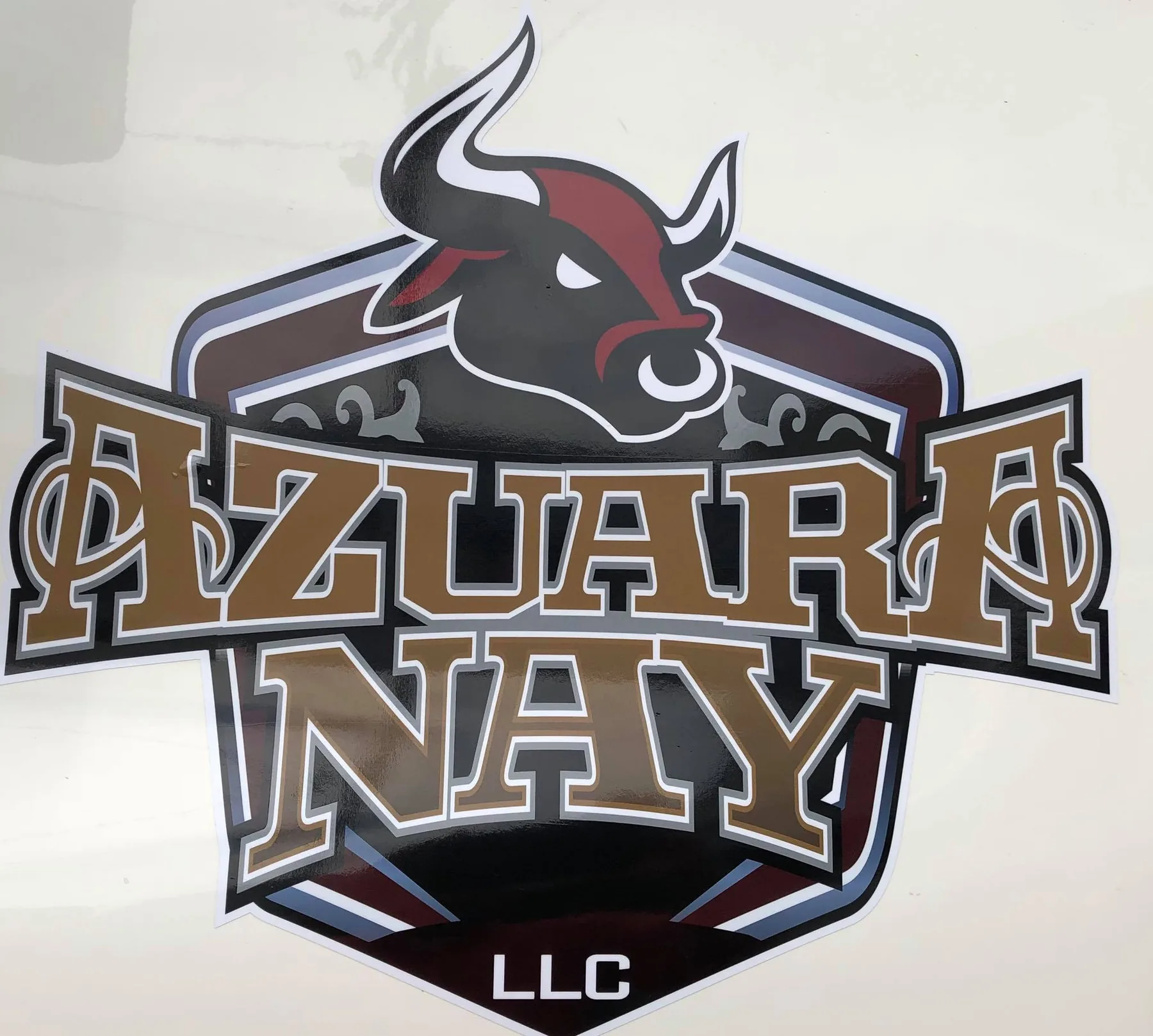 Contour-cut Azuara Nay LLC bull logo decal applied to a white panel