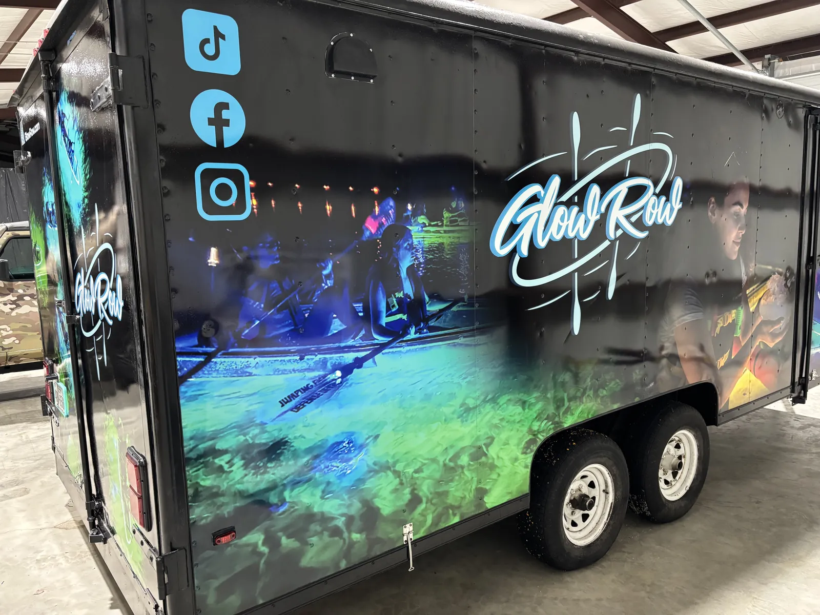 Enclosed trailer wrapped with neon Glow Row event graphics