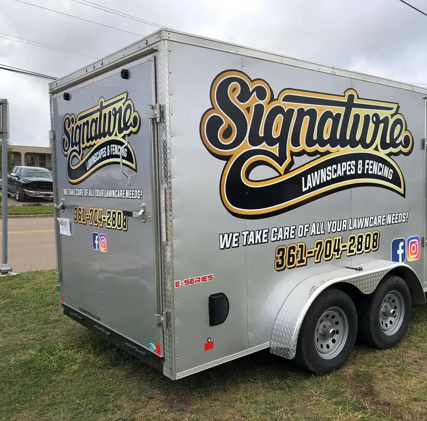 Enclosed cargo trailer wrapped with Signature Lawnscapes and Fencing graphics and contact details